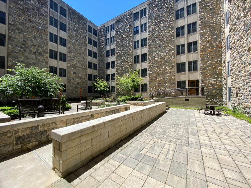 A view of Pritchard Hall's large central courtyard, with pathways, steps, trees, and green space. 