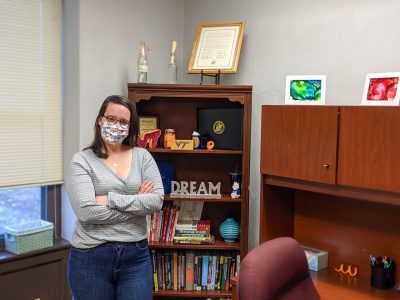 Amanda Eagan stands in her office in the Housing & Residence Life suite of New Hall West. Photo by Stephen Henninger for Virginia Tech.