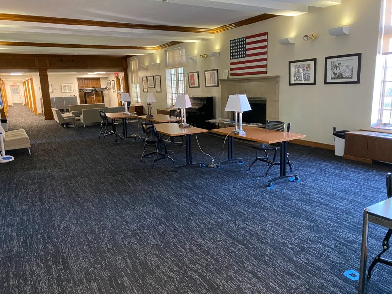 The large common area on the first floor of Hillcrest, which has tables, chairs, a piano, and plenty of space for students to study or socialize.