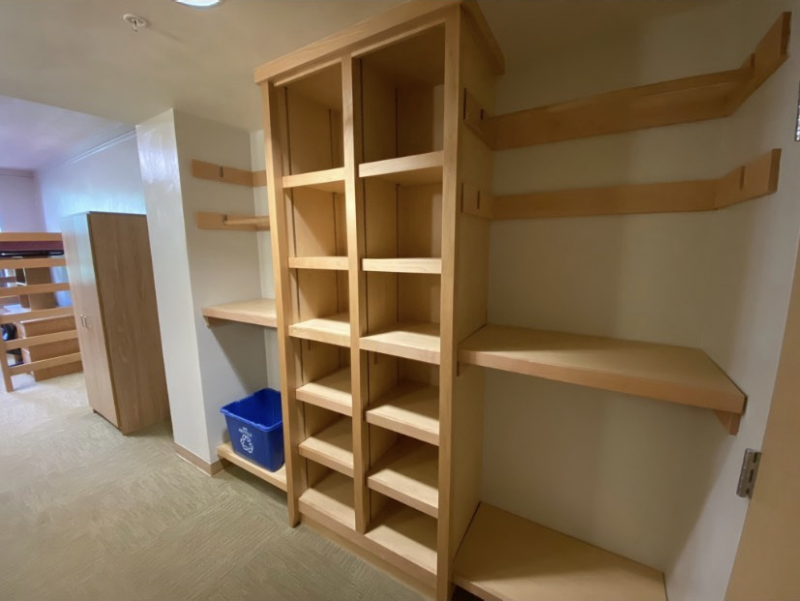 A view of the unique built-in storage in a room in New Hall West, which consists of a series of shelves built out of wood of varying sizes.