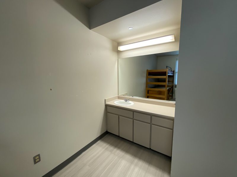 Another view into a room in Payne Hall, focused on the built-in sink and mirror.