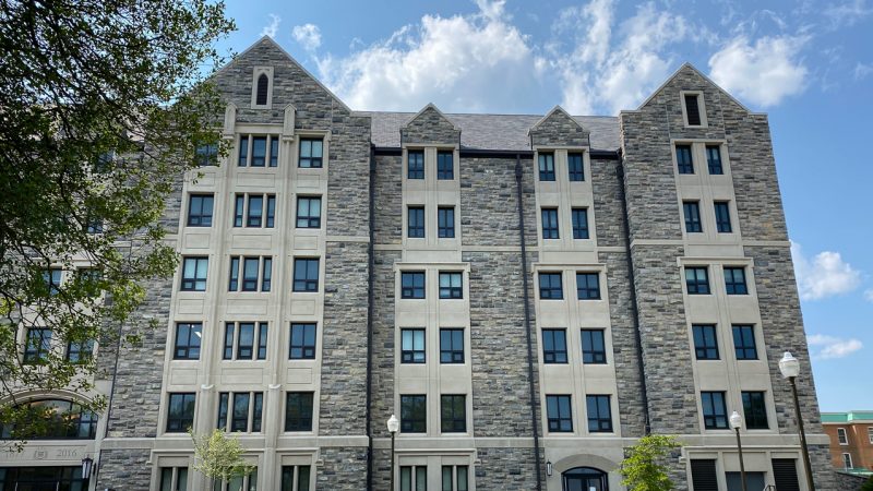 A view of the side of Pearson West that faces Alumni Mall. The building is lined with Hokie Stone and dotted with windows.