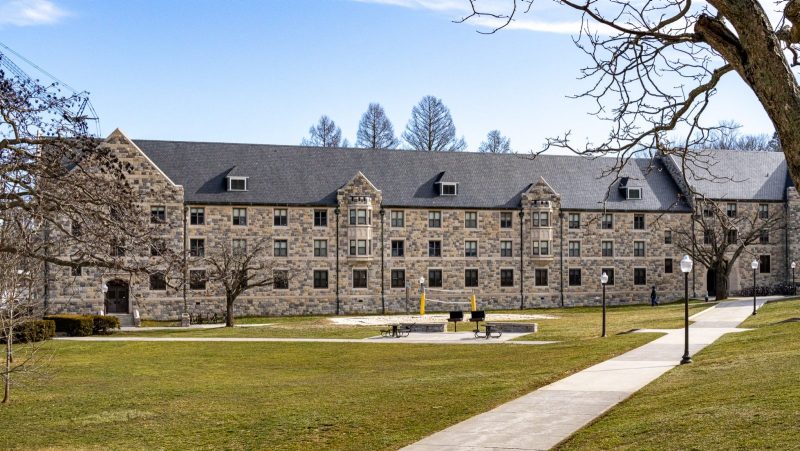 A view of one side of Whitehurst Hall, with Hokie Stone meeting a grassy lawn.