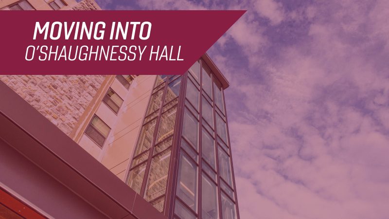 A view up towards the sky showing the iconic glass stairwell in the front of O'Shaughnessy Hall, with the title "Moving Into O'Shaughnessy Hall."