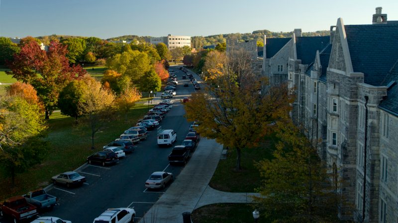Cars parked along the Drillfield on a beautiful day at Virginia Tech's campus. 