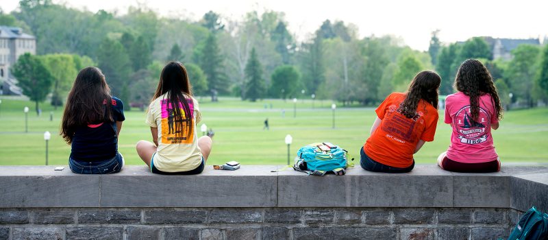 Students sitting looking out on to the Drillfield
